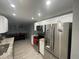 Modern kitchen showcasing white cabinets and stainless steel appliances, adjacent to dining area at 1001 Arden St, Longwood, FL 32750