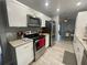 Modern kitchen featuring granite countertops, stainless steel appliances, and white cabinets with lots of light at 1001 Arden St, Longwood, FL 32750