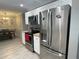Well-equipped kitchen boasts stainless steel appliances, white cabinets, and granite countertops at 1001 Arden St, Longwood, FL 32750