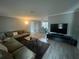 Stylish living room boasts a plush sectional, modern TV setup, and seamless flow into the dining area at 1001 Arden St, Longwood, FL 32750