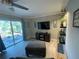 Bright living room featuring a sliding glass door, large TV, decor, and cozy seating with lots of natural light at 1001 Arden St, Longwood, FL 32750