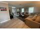 Bright living room features a comfortable sectional, plush rug, and abundant natural light from the windows at 1001 Arden St, Longwood, FL 32750