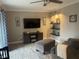 Comfortable living room featuring a large TV, stylish decor, and cozy seating with lots of natural light at 1001 Arden St, Longwood, FL 32750