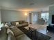 Open-concept living room showcases a cozy sectional, a stylish coffee table, and easy access to the breakfast bar at 1001 Arden St, Longwood, FL 32750