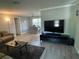 Modern living room features a TV setup and seamless flow into the dining area at 1001 Arden St, Longwood, FL 32750