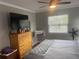 Well-lit bedroom boasts large windows, crown moulding, a ceiling fan, dresser, and window at 1001 Arden St, Longwood, FL 32750
