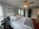 Comfortable bedroom features windows, crown moulding, ceiling fan, entry to primary bathroom, and closet at 1001 Arden St, Longwood, FL 32750