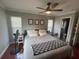 Comfortable bedroom features windows, crown moulding, ceiling fan, and entry to primary bathroom at 1001 Arden St, Longwood, FL 32750