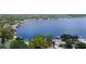 Aerial view of the waterfront community along the lake, surrounded by lush greenery and mature trees at 101 E Lauren Ct, Fern Park, FL 32730