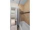 This bathroom features a tub, tiled walls, and shelving for storage at 101 E Lauren Ct, Fern Park, FL 32730