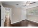 This bedroom features hardwood floors, a ceiling fan, closet, and a bright window offering ample natural light at 101 E Lauren Ct, Fern Park, FL 32730