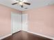 This bedroom features hardwood floors, a ceiling fan, and a large closet with bright light at 101 E Lauren Ct, Fern Park, FL 32730