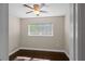 This bedroom features hardwood floors, a ceiling fan, and a bright window offering ample natural light at 101 E Lauren Ct, Fern Park, FL 32730