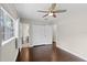 This bedroom features hardwood floors, a ceiling fan, closet, and a bright window offering ample natural light at 101 E Lauren Ct, Fern Park, FL 32730