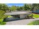 View of the home with a carport and mature landscaping in the front yard at 101 E Lauren Ct, Fern Park, FL 32730