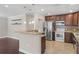 Modern kitchen with stainless steel appliances, granite countertops, and dark wood cabinetry at 101 E Lauren Ct, Fern Park, FL 32730