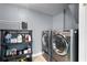 This laundry room has a gray paint, metal shelving, and newer appliances offering efficient functionality at 101 E Lauren Ct, Fern Park, FL 32730