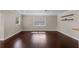 Open living space featuring hardwood floors, bright window, and modern shelving at 101 E Lauren Ct, Fern Park, FL 32730