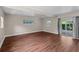 Bright living room features hardwood floors, a window, and sliding glass doors to the exterior at 101 E Lauren Ct, Fern Park, FL 32730