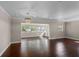 Open-concept living area with beautiful hardwood floors, large sliding door, and a transom window at 101 E Lauren Ct, Fern Park, FL 32730