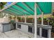 The outdoor kitchen has a stainless steel grill, a prep area, and a sink for summer barbecues at 101 E Lauren Ct, Fern Park, FL 32730