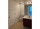 Bathroom featuring tile floors, cherry vanity and a decorative niche at 10128 Hartford Maroon Rd, Orlando, FL 32827