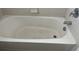 Clean and standard white bathtub with chrome fixtures in a tiled bathroom at 10128 Hartford Maroon Rd, Orlando, FL 32827