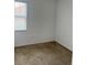 Simple bedroom with neutral carpet and a window providing natural light at 10128 Hartford Maroon Rd, Orlando, FL 32827