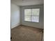 Well-lit bedroom with carpeted floors and a window with natural light at 10128 Hartford Maroon Rd, Orlando, FL 32827