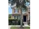 Close-up of a tan two-story townhome showcasing well-manicured landscaping and front entryway at 10128 Hartford Maroon Rd, Orlando, FL 32827