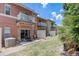 Townhome backyard featuring private balconies, a patio with dining set and an AC unit on a sunny day at 1041 Park Ridge Cir, Kissimmee, FL 34746