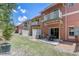 Exterior view showcasing private balconies, patios with dining sets, AC unit and colorful townhome exteriors at 1041 Park Ridge Cir, Kissimmee, FL 34746