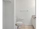 Modest bathroom with a toilet, sink, and minimal decor at 1041 Park Ridge Cir, Kissimmee, FL 34746