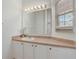 Bathroom featuring a large mirror, white sink, and vanity with good lighting at 1041 Park Ridge Cir, Kissimmee, FL 34746