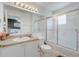 Bathroom featuring a shower with glass doors, a vanity, and neutral tile flooring at 1041 Park Ridge Cir, Kissimmee, FL 34746