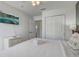 Bright bedroom with white walls, ceiling fan, TV, and bedside table at 1041 Park Ridge Cir, Kissimmee, FL 34746