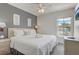 Bedroom featuring a king bed, ceiling fan, window with pool view and neutral carpet at 1041 Park Ridge Cir, Kissimmee, FL 34746