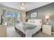 Bedroom with a large bed, ceiling fan, and sliding glass doors leading to a balcony at 1041 Park Ridge Cir, Kissimmee, FL 34746