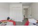 Bedroom with twin beds, a closet, and a doorway leading to another room at 1041 Park Ridge Cir, Kissimmee, FL 34746