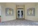 Welcoming entrance of a building with decorative wall designs and double glass doors for natural light at 1041 Park Ridge Cir, Kissimmee, FL 34746