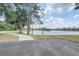 Scenic lake view with walking path, trees, and benches for outdoor enjoyment at 1041 Park Ridge Cir, Kissimmee, FL 34746