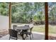 Covered patio with a dining set offers a relaxing outdoor space surrounded by lush greenery and natural light at 1041 Park Ridge Cir, Kissimmee, FL 34746