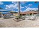 Relaxing community pool area with sun loungers, palm trees, covered seating, and lush landscaping at 1041 Park Ridge Cir, Kissimmee, FL 34746
