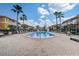 Community pool surrounded by lounge chairs and palm trees, perfect for relaxation and recreation at 1041 Park Ridge Cir, Kissimmee, FL 34746