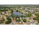 Expansive aerial view of a community, highlighting a central lake and surrounding residential homes at 11113 Sylvan Pond Cir, Orlando, FL 32825