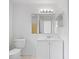 Bathroom featuring a toilet, sink, mirror, and vanity with storage at 11113 Sylvan Pond Cir, Orlando, FL 32825
