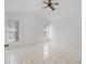 Spacious bedroom with tiled floors, ceiling fan, and two windows for ample light at 11113 Sylvan Pond Cir, Orlando, FL 32825