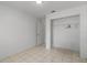 Bright bedroom featuring tiled floors and a spacious closet with ample storage at 11113 Sylvan Pond Cir, Orlando, FL 32825