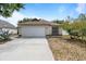 Inviting single-story home with a large front yard and attached garage at 11113 Sylvan Pond Cir, Orlando, FL 32825
