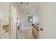 Galley kitchen featuring white appliances, wood cabinets, and tile flooring at 11113 Sylvan Pond Cir, Orlando, FL 32825